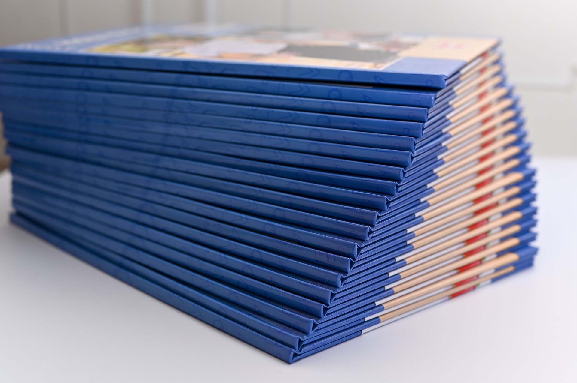 photo albums are stacked on the table