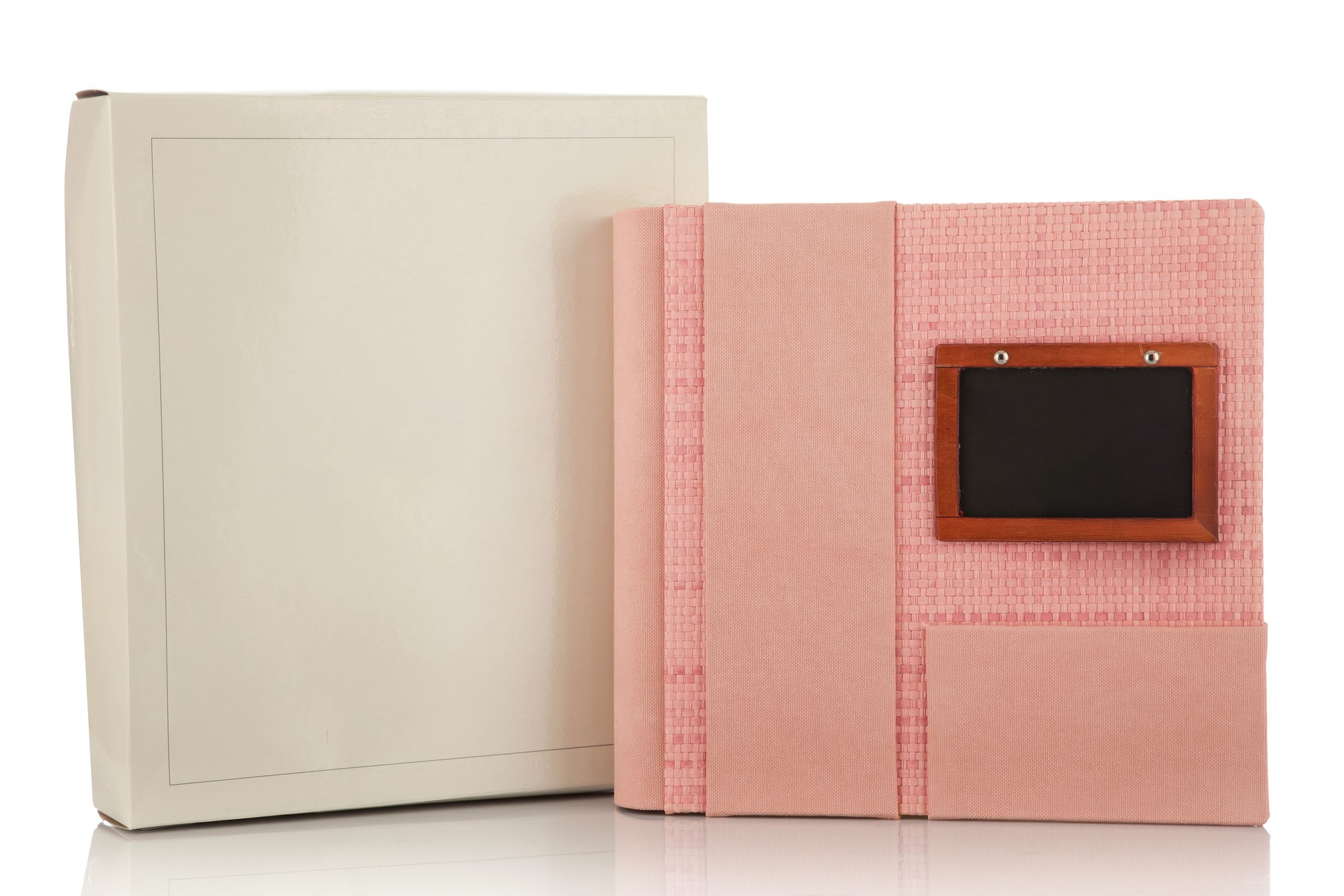 Pink photo album with its case and a small blackboard for writing on a white background