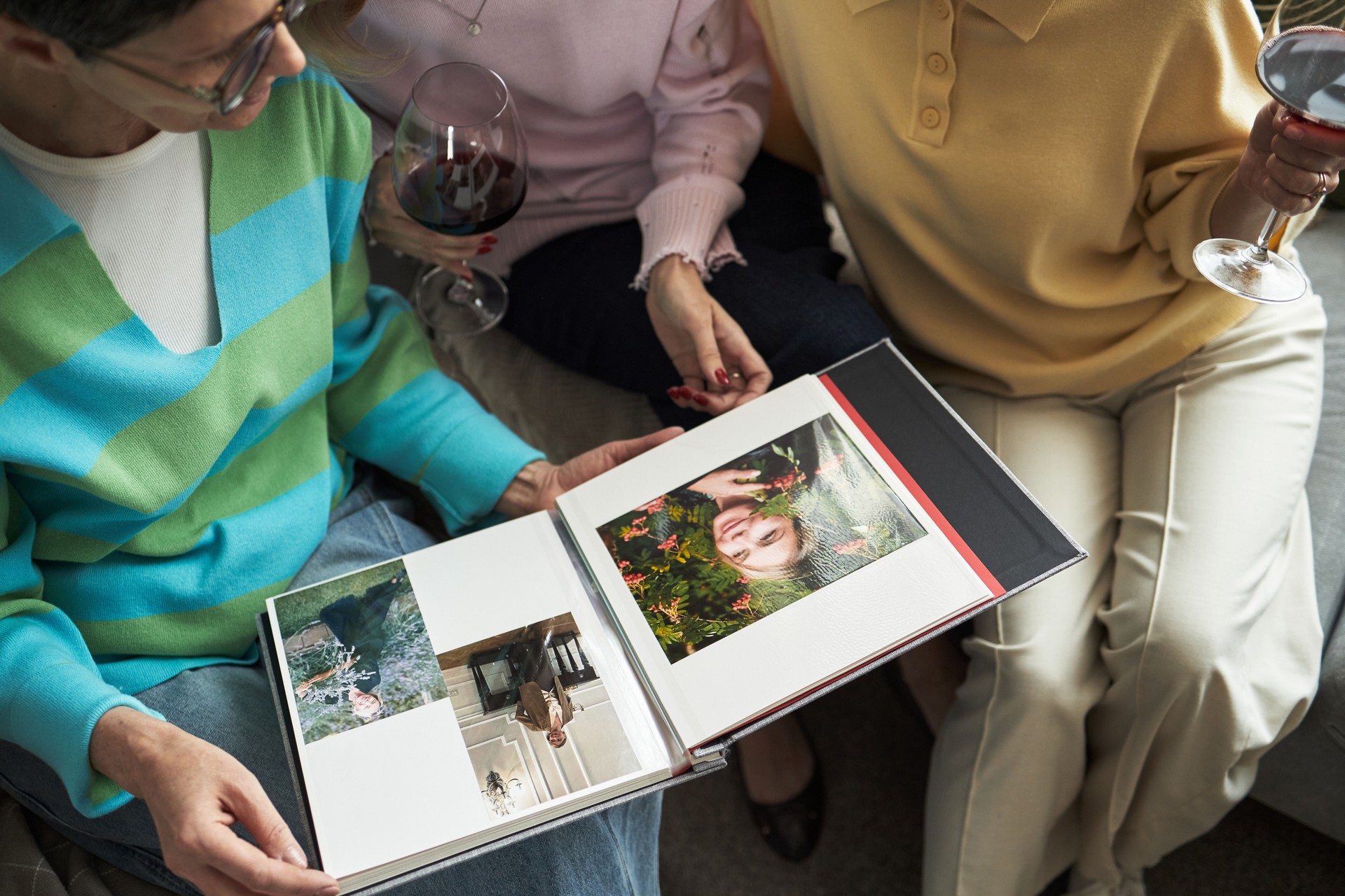 Middle Aged Caucasian Women Sharing Memories While Looking through Photo Album